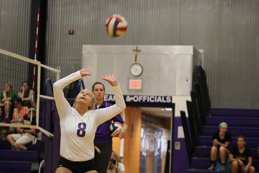 Sophomore Allie Weinrich gets in one last practice set before the game starts.