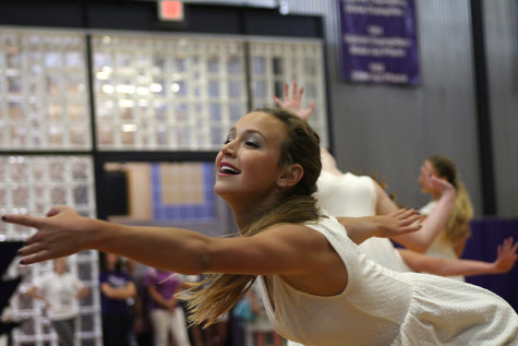 Senior Rachel Young performs in the dance team's routine during the pep assembly Sept. 4. 