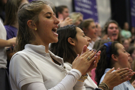 Seniors Anna Fotouhi, Delaney Dorman and Kate O'Keefe join in singing the school song at the end of the pep assembly Sept. 4. 