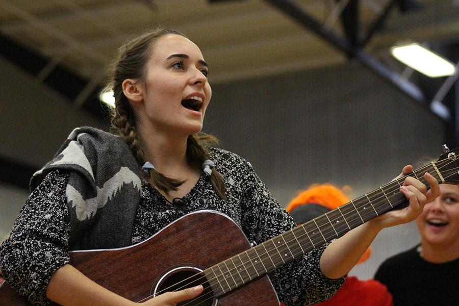 Senior Abby Hamilton, who played campus minister Stephanie Pino-Dressman,  leads the faculty in a remix of the hymn "Sanctuary."