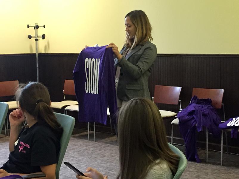 Mulder shows the shadows the long-sleeve spirit shirt that they get to take home after their visit. 