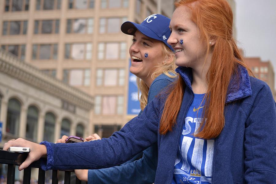 Seniors Audrey Calovich and Rachael Beck watch with anticipation as the Royals World Series parade begins. The parade started at the Sprint Center and finished at Union Station.