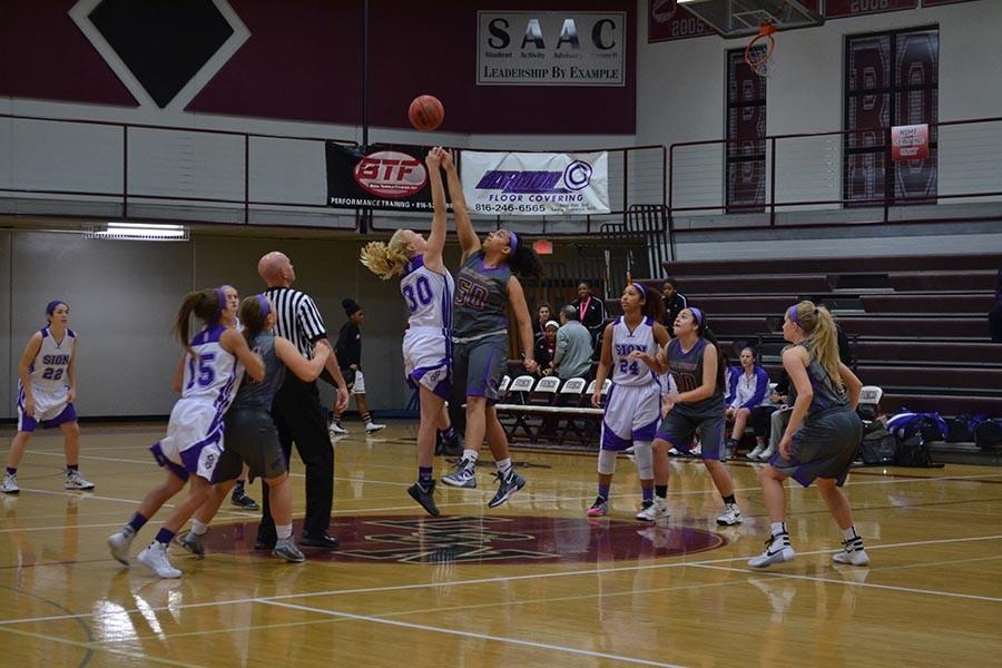 Senior Rachael Beck tips off for the Storm against Blue Springs player Taylor Overman.