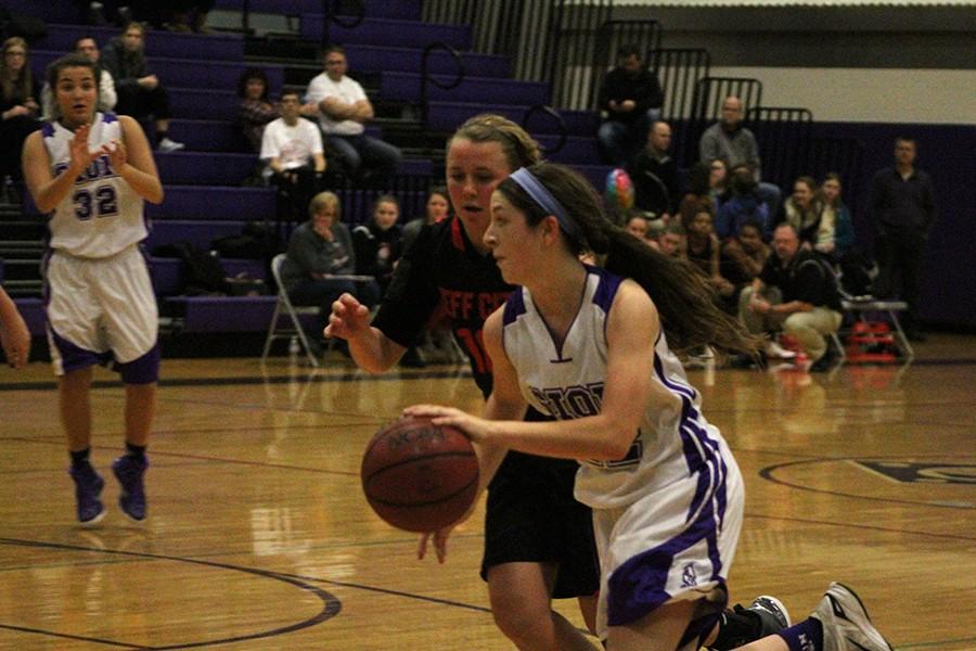 Sophomore Sarah Totta dribbles past Jeff City's defender, Taylor LePage.