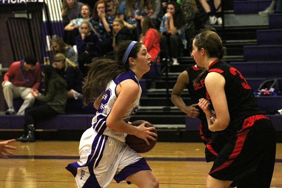 Sophomore Sarah Totta goes in for a layup against Megan Foster from Jeff City.