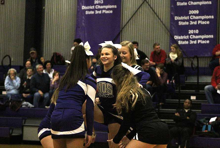 Sophomore Madi Clark prepares to go up in a stunt during halftime.