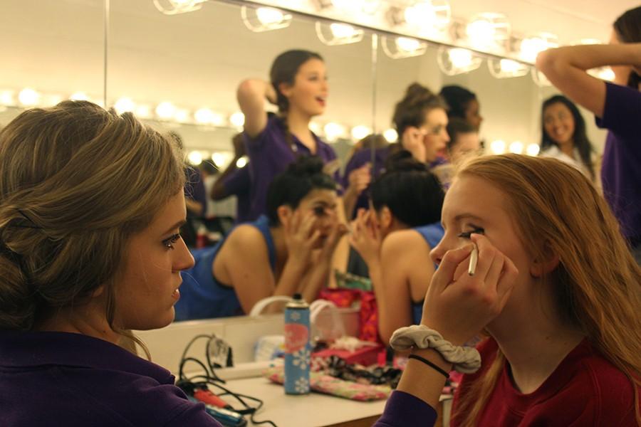 Sophomore Emilie Connors does freshman Elizabeth Ericson's eye makeup before the Jan 21 dress rehearsal of "Thoroughly Modern Millie." 