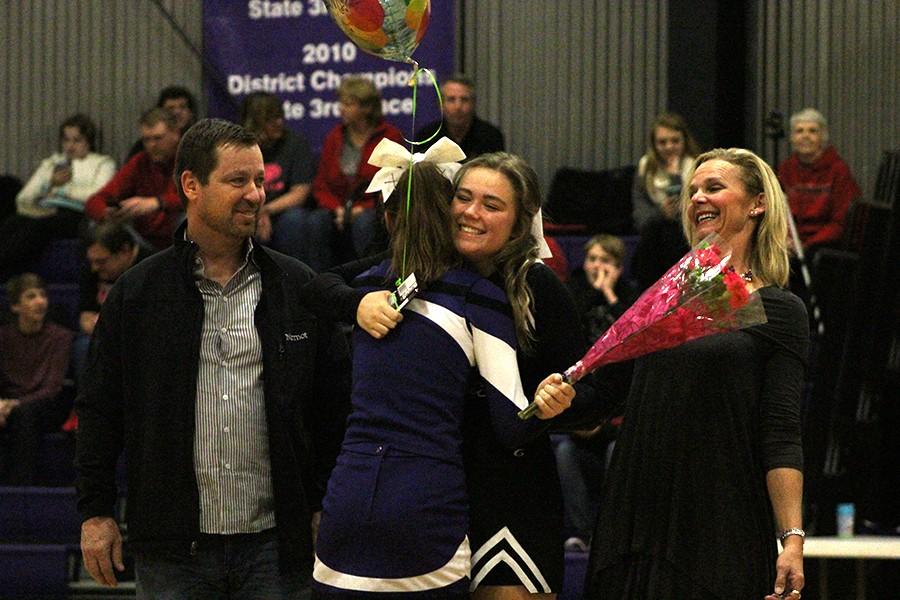 Senior Emmie Gragg is presented with a gift from sophomore Caroline Bono.