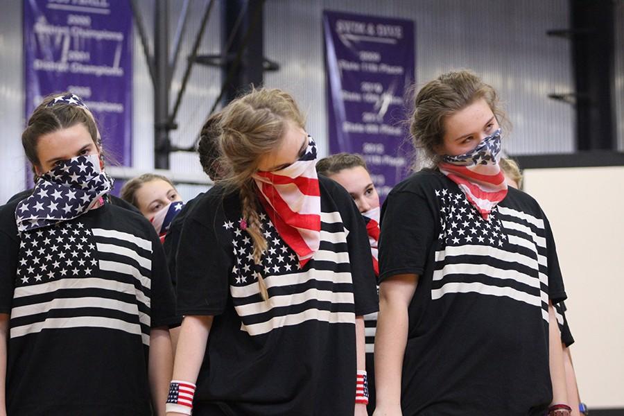 Seniors Stephanie Ostrander, Katie Pendergast and Emmie Gragg look out to the crowd during the senior class dance.