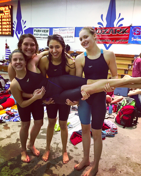 Seniors Kat Qamar, Nathalie Barbeau and sophomore Ellie Magsamen hold sophomore Meredith Oswald. The four will be swimming the 200 meter medley relay at the State meet on Feb. 19 and 20.