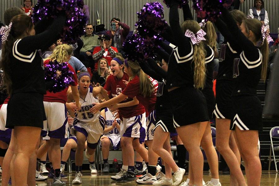 Junior Madeline Dercher sprints through the cheer pre-game tunnel. 