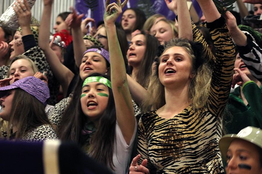 Juniors Natalie Arreguin, Maria Arroyo and Katia Hauptmann join in on the cheers while dressed in "Welcome to the Jungle" theme at the Sion v. St. Teresa's game Jan. 29. 