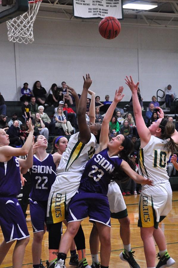 Sion and O'Hara players reach for the rebound during the first quarter of the Feb. 3 game. Sion won 70-51. 