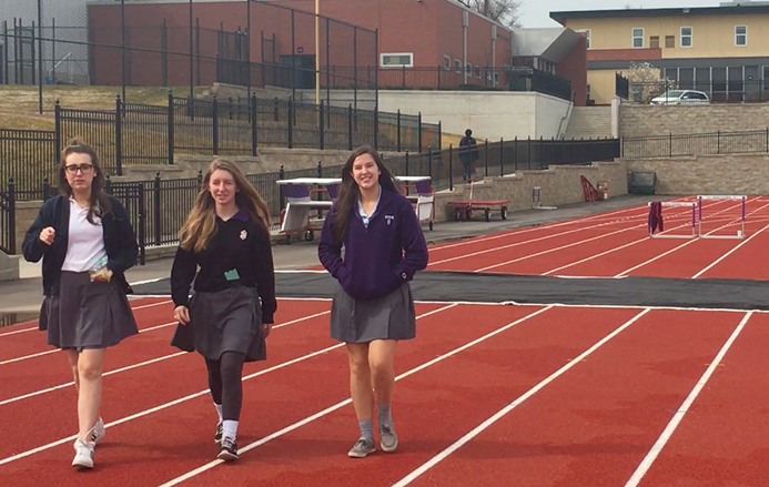 Seniors Olivia Neal, Isadora Comens and Caroline Hodes walk the track during lunch to promote a healthy lifestyle as a part of the Project Purple initiative. 