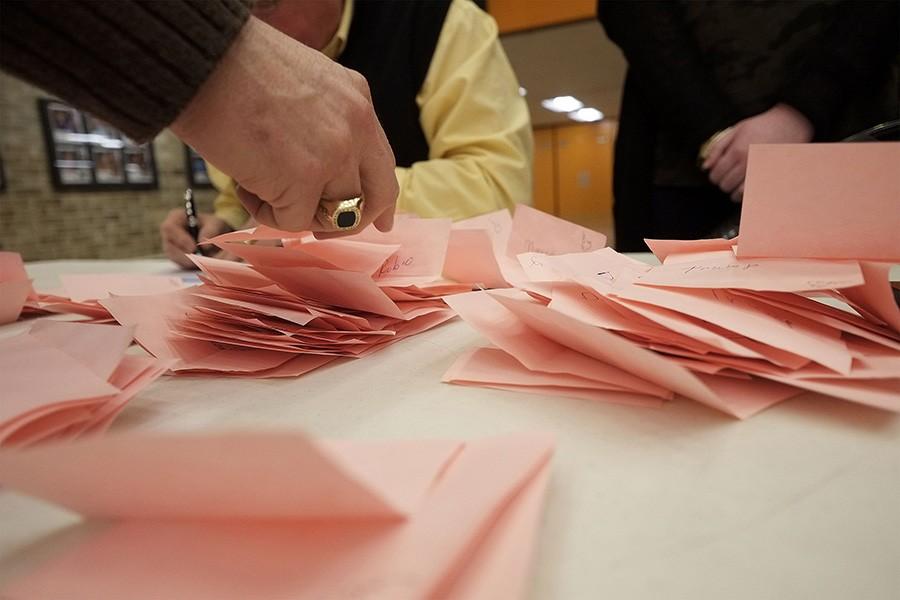 Ballots are sorted into piles by candidates for counting during the Woodbury County Republican Precinct 28 caucus at East High School in Sioux City, Iowa, on Monday, Feb. 1, 2016. (Jerry Mennenga/Zuma Press/TNS)