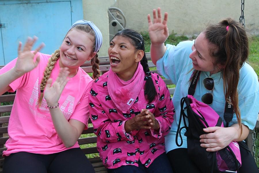 Juniors Lydia Allegri and Esobel Moore sit with a girl at Los Gozosos in Chimaltenango, Guatemala. Los Gozosos is an orphanage and school for special needs children. 