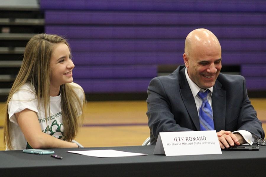 Senior Izzy Romano and her father, Tony Romano, laugh at the stories being told from Izzy's teammates. 