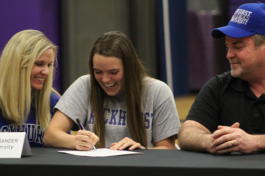 Senior Stephanie Ostrander, accompanied by her parents Cyndi and Bud Ostrander, signs her letter of intent to play soccer at Rockhurst University.