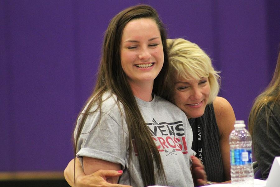 Senior Molly McEnerney's mother, Sarah McEnerney, hugs her as she finishes signing her letter of intent.