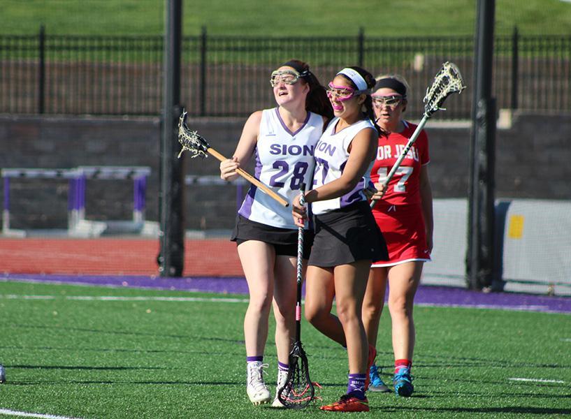 Sophomore Aidan McEnerney congratulates senior Kat Qamar on scoring during the game.