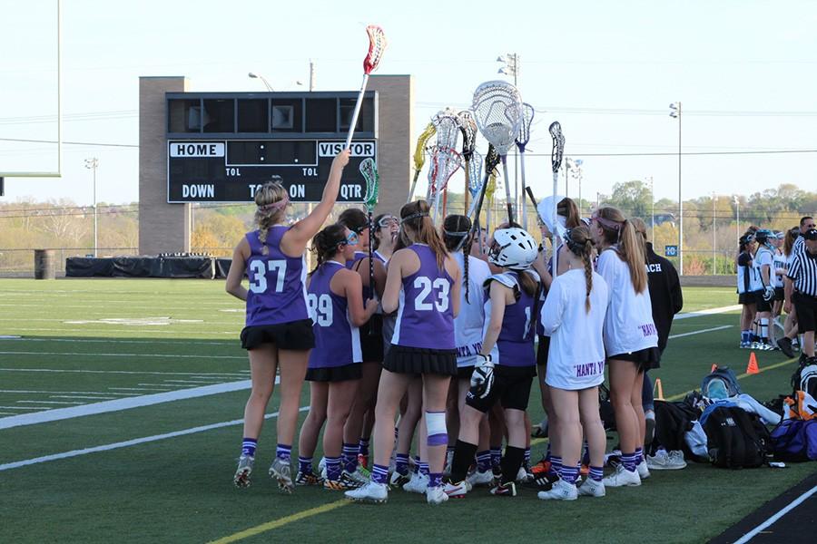 The lacrosse team prepares to start their game against Shawnee Mission East.