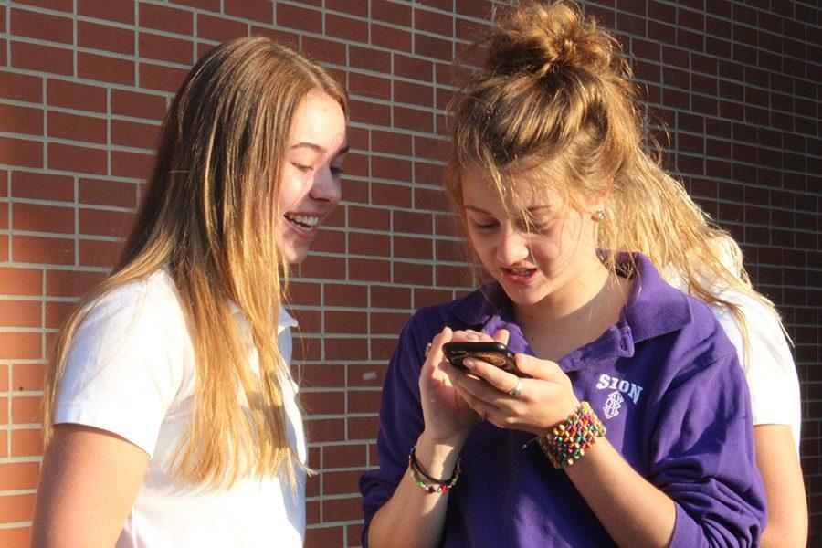 Seniors Erin Quinn and Caitlyn Swope catch up at the senior tailgate.