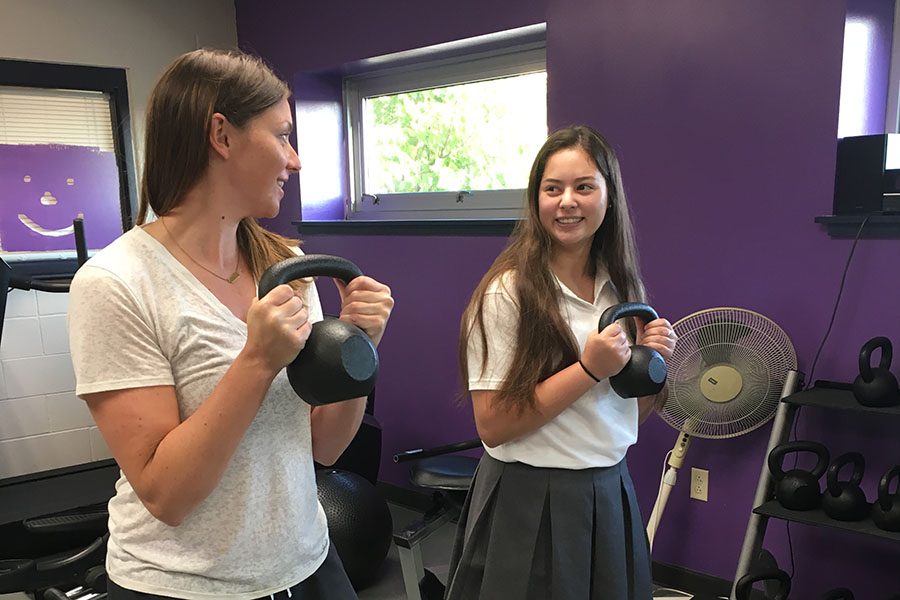 Assistant Athletic Director Sarah Johnson gives Junior Sydney Crawford some pointers before school. "I always want to make the girls feel like they can come to me," Johnson said.