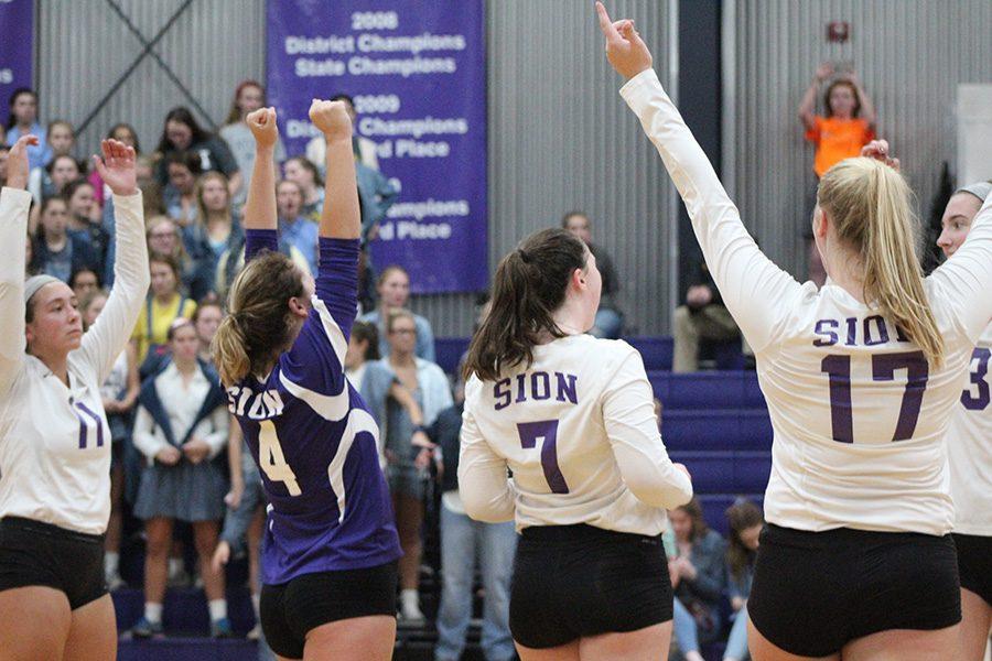 Senior co-captain Ali Odermann and teammates celebrate a winning play at the start of the game.