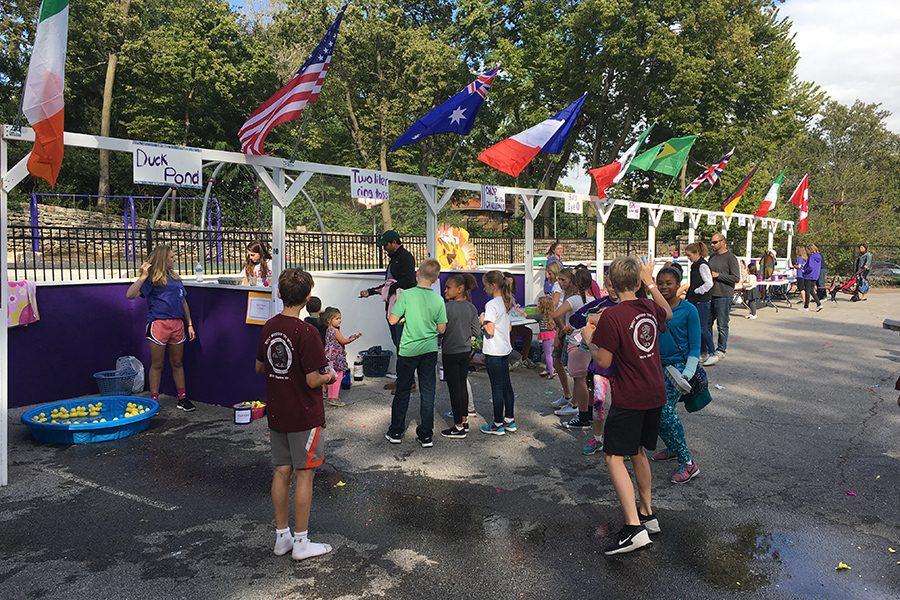 Several kids line up for mini games while waiting their turn to play.