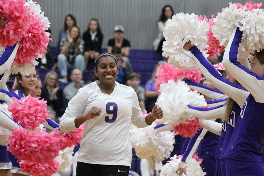 Senior Sophie Roberts runs through the cheerleader's tunnel for her last home game.