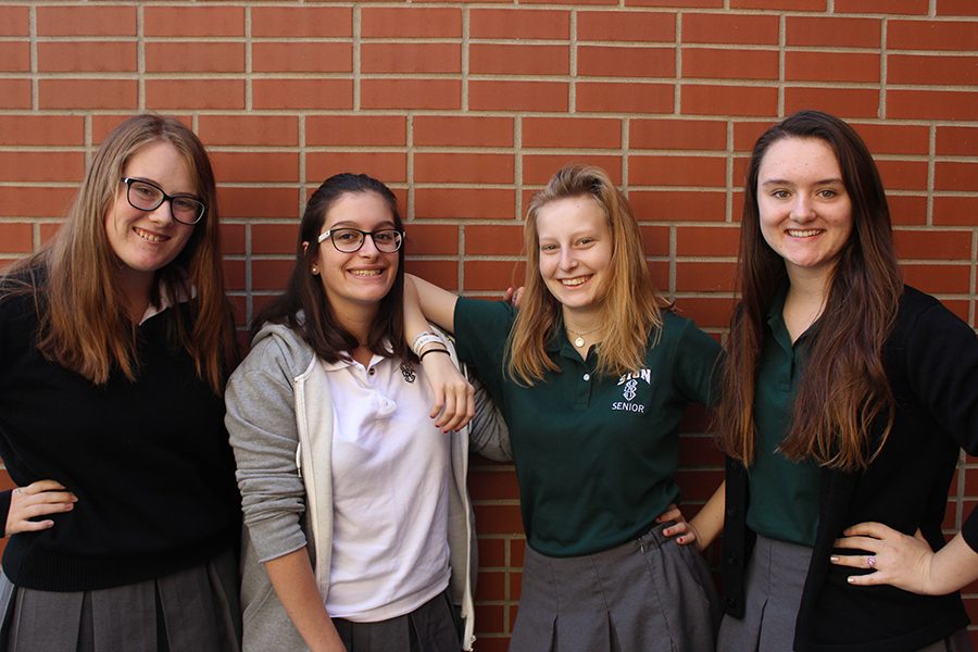 Seniors Josie Weck and Claire Ivey pose with their French exchange students, Julie Odille and Milla Bergandi, respectively.