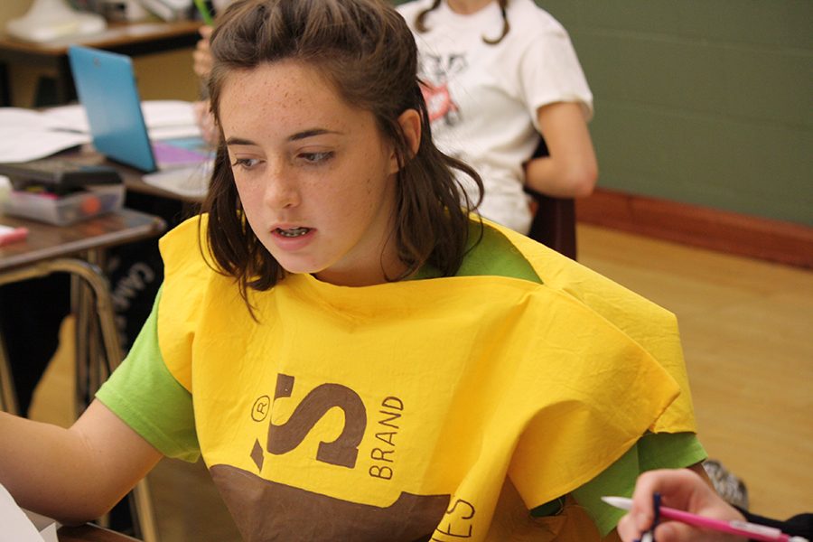 Freshman Jackie Campbell works on her assignment during class in her “Charlie and the Chocolate Factory” costume.