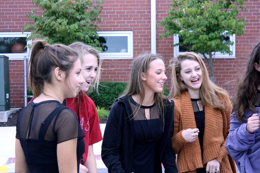 Seniors Katie Buhrmeister, Gracie Snider, Madeline Dercher and Erin Quinn converse with one another during a break. 