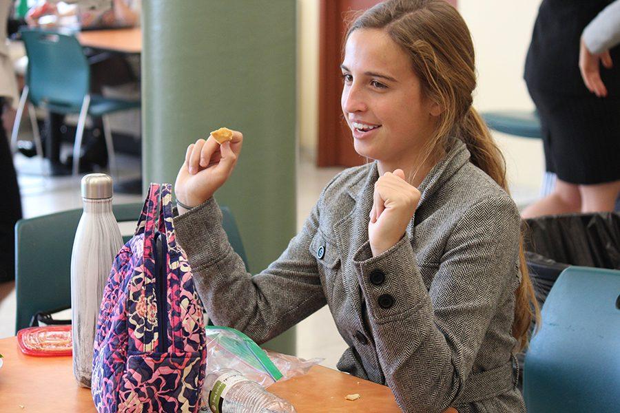 Junior Mandy Mayer enjoys her lunch while wearing her business clothing.