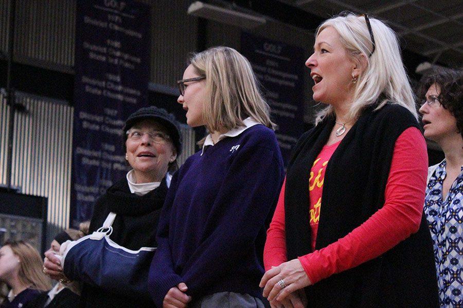 Junior Caroline Bono is joined by her grandmother, left, and her mother French teacher Liz Bono, right, at the Dec. 8 Mass. 