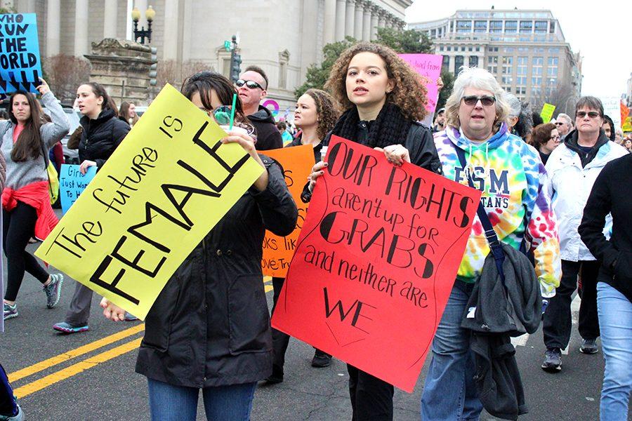 Many protestors created their own signs for the march. Here, women carry their signs echoing female power.