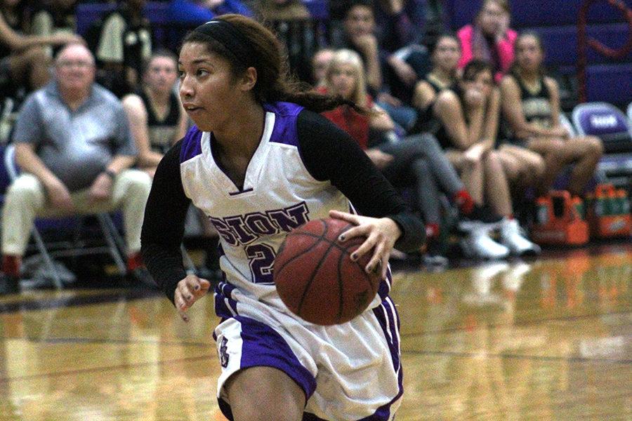 Junior Amaya Adams dribbles down the court to go for a layup.