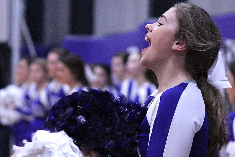 Junior cheerleader Peyton Dow cheers on the basketball team during the second half.