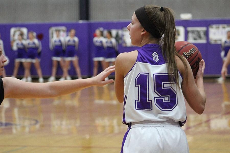 Senior Madeline Dercher looks to make a play while under pressure from the opposing team.