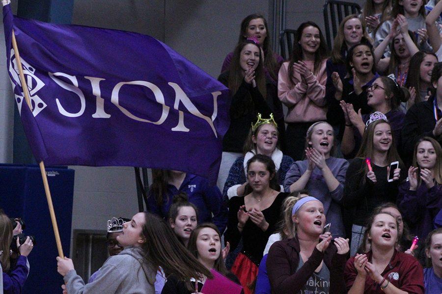 Junior Carolyn Dickey waves the school flag in between points.