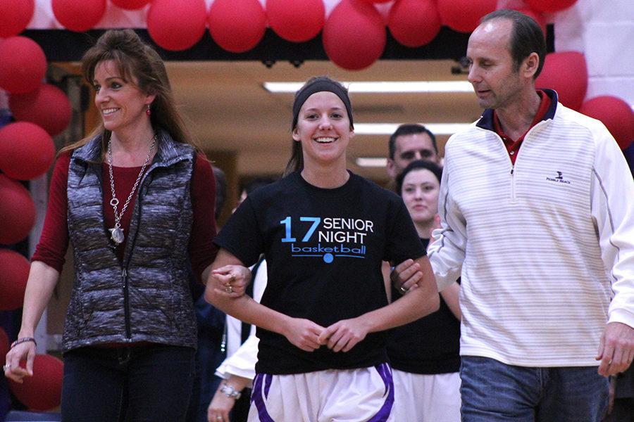 Senior Madeline Dercher walked to the center of the court with her parents to receive flowers to honor her time spent on the team.