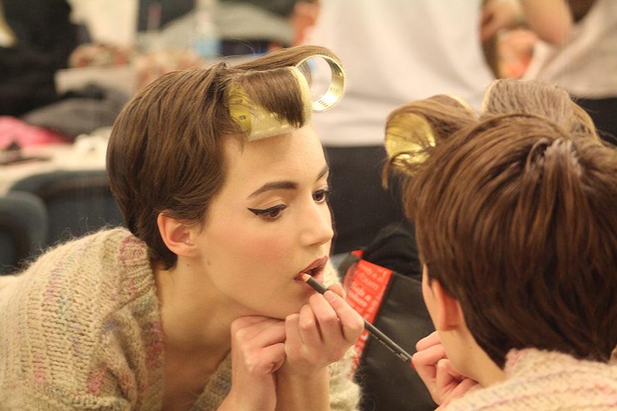 Sophomore MK Shevlin adds the finishing touches to her makeup before the start of the final dress rehearsal March 1.