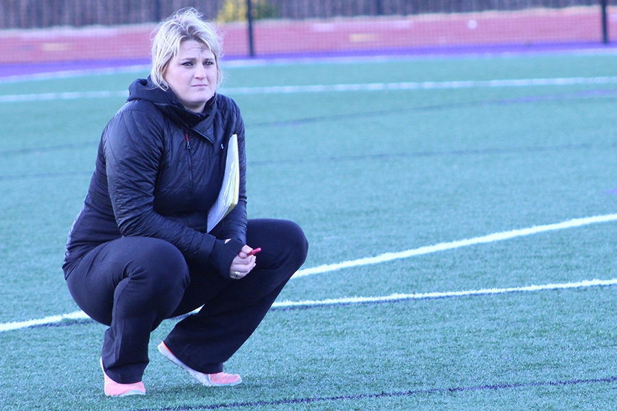 Varsity Lacrosse Head Coach Molly Crawford watches as players participate in tryouts.