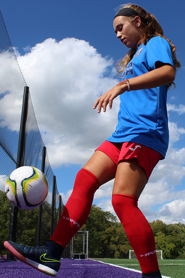 Freshman Felicia Knox juggles the soccer ball while sporting the uniform she wore in Columbia as part of the U.S. Youth Futsal National Team.