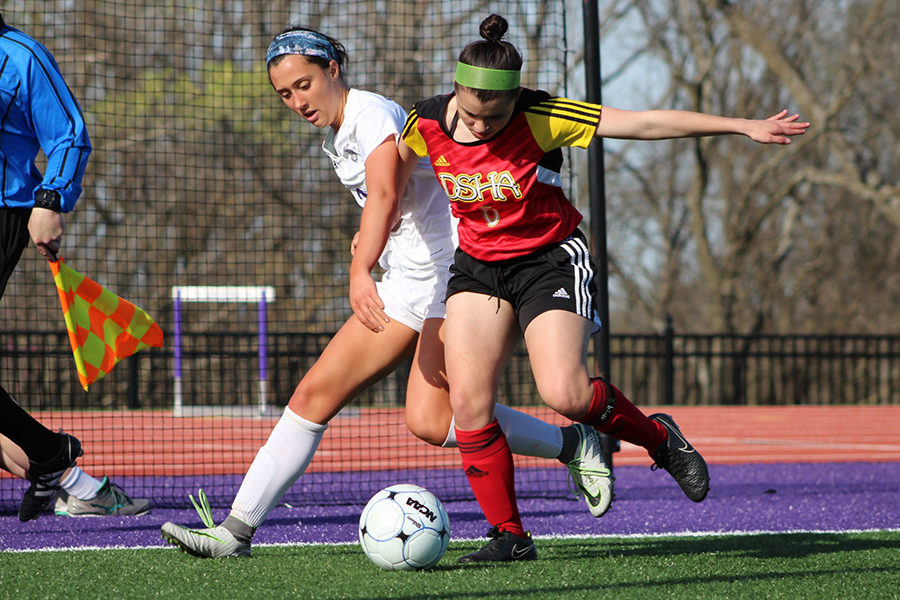 Junior Meghan Frerking faces pressure from her opponent while trying to get the ball.