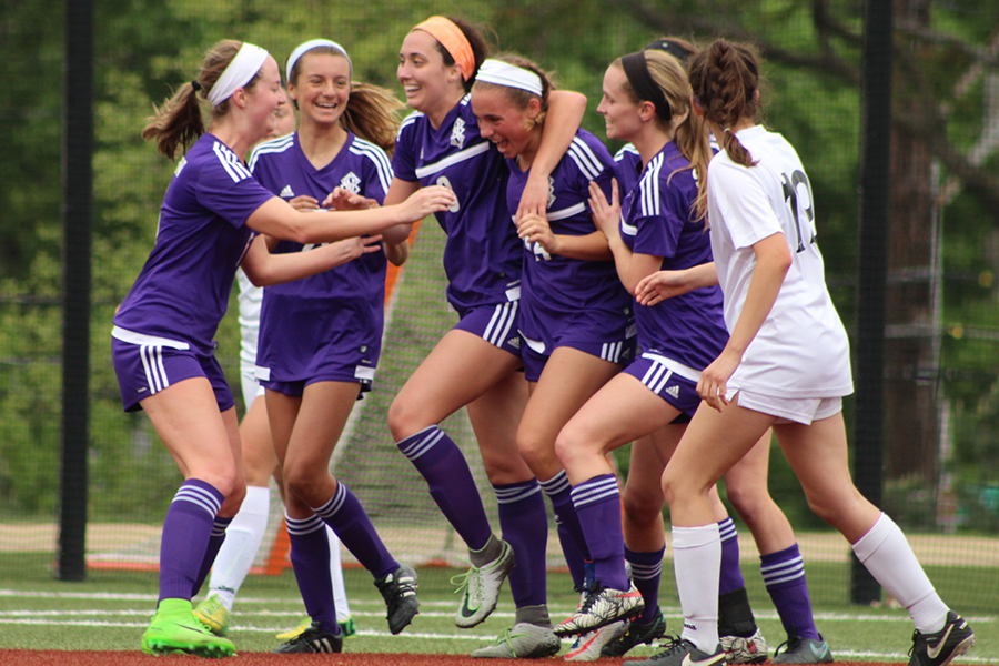 Senior Angela Neunuebel, freshman Rose Orrick and juniors Meghan Frerking and Haley Ulowetz run to sophomore Gabby Grimaldi after her goal.