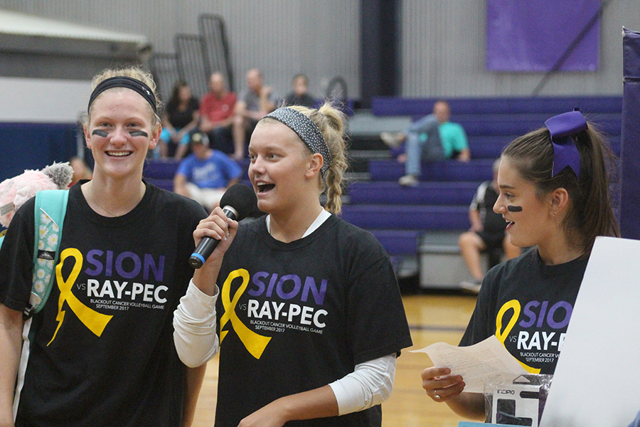 Seniors Ella Anstoetter, Allie Weinrich and Lauren Ismert present their senior service project “Bags of Fun KC” before the volleyball game Sept. 20.