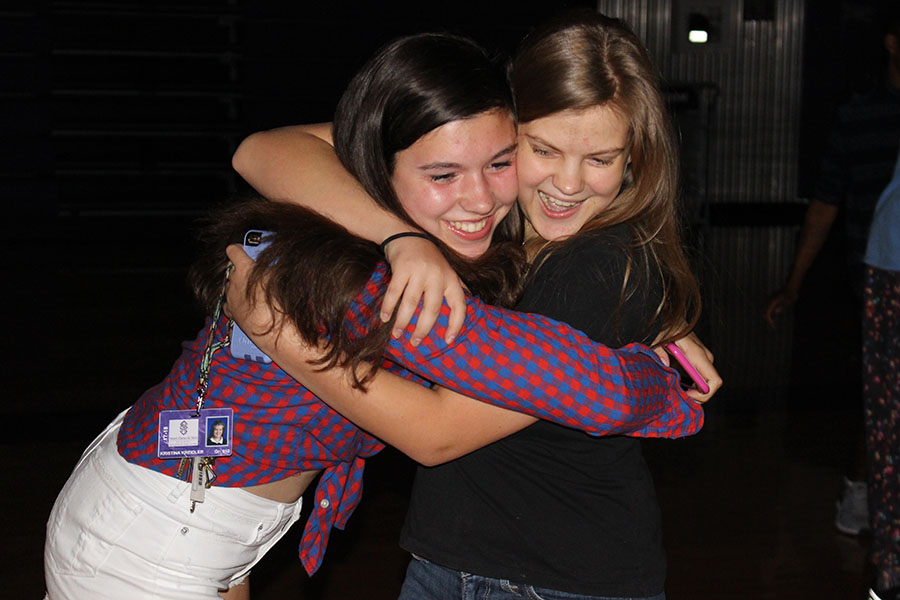 Sophomores Elizabeth Schirger and Kristina Kriedler laugh and hug upon seeing each other at Fall Dance Sept. 9.