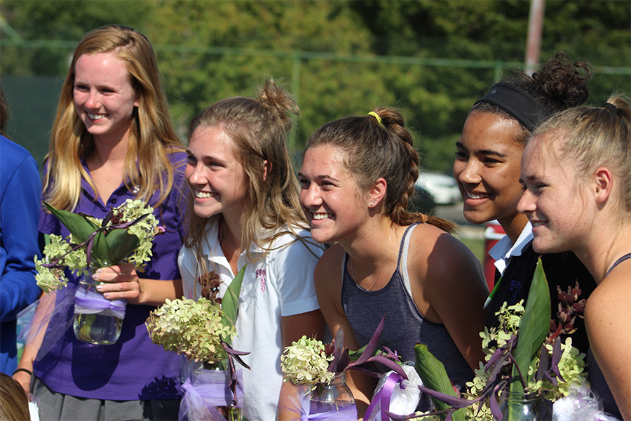 After receiving their bouquets from the underclassmen, seniors Sarah Hogan, Mary Kathryn Barrett, Lanie Jones, Lauren Graves and Emma Miller pose for a picture before their matches. 