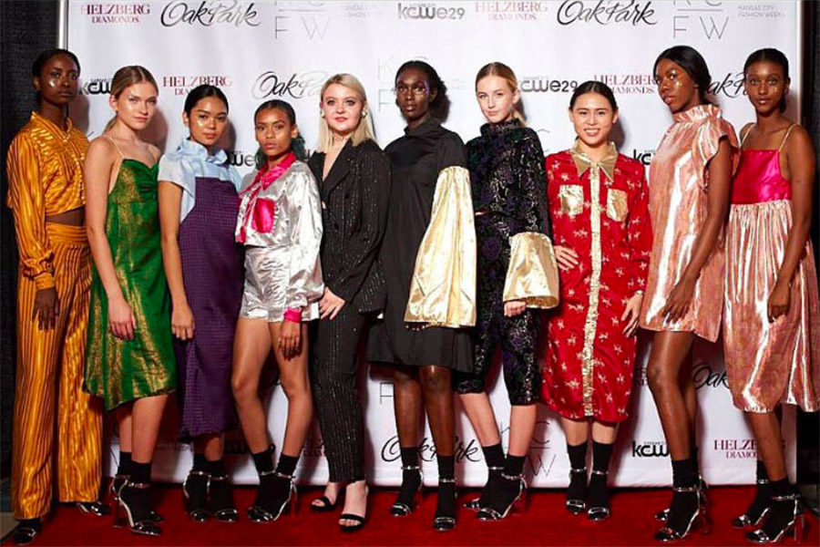 Senior Emilie Connors (second from the left), poses with other models after walking in one night of the Kansas City Fashion Week.